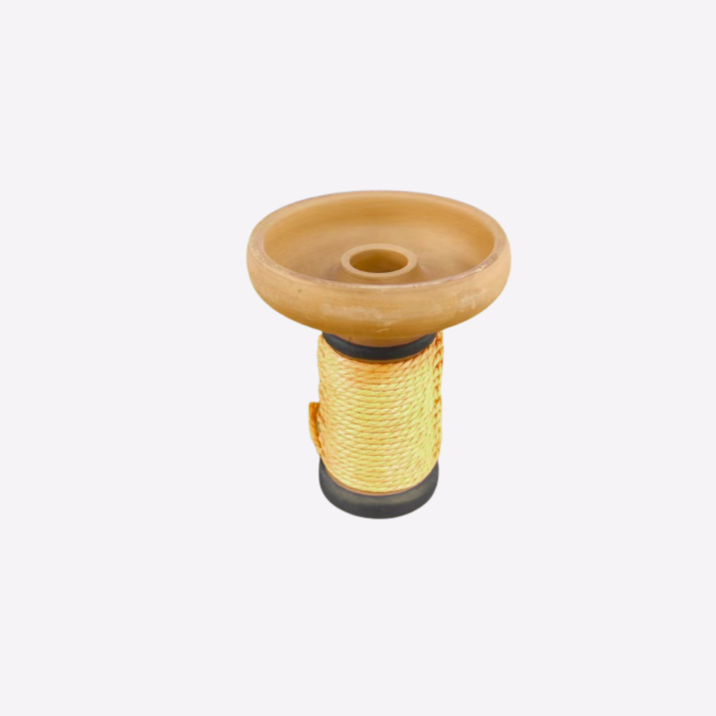 Spool of yellow thread with a clay bowl on a white background